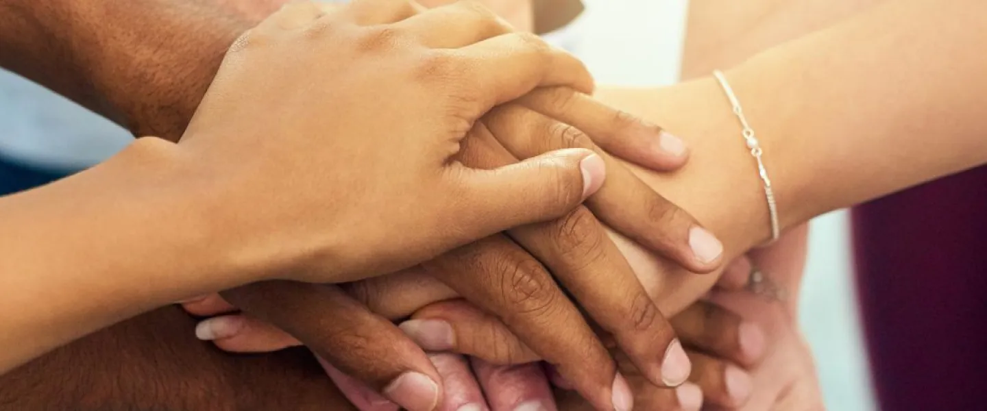 group of hands stacked on top of each other