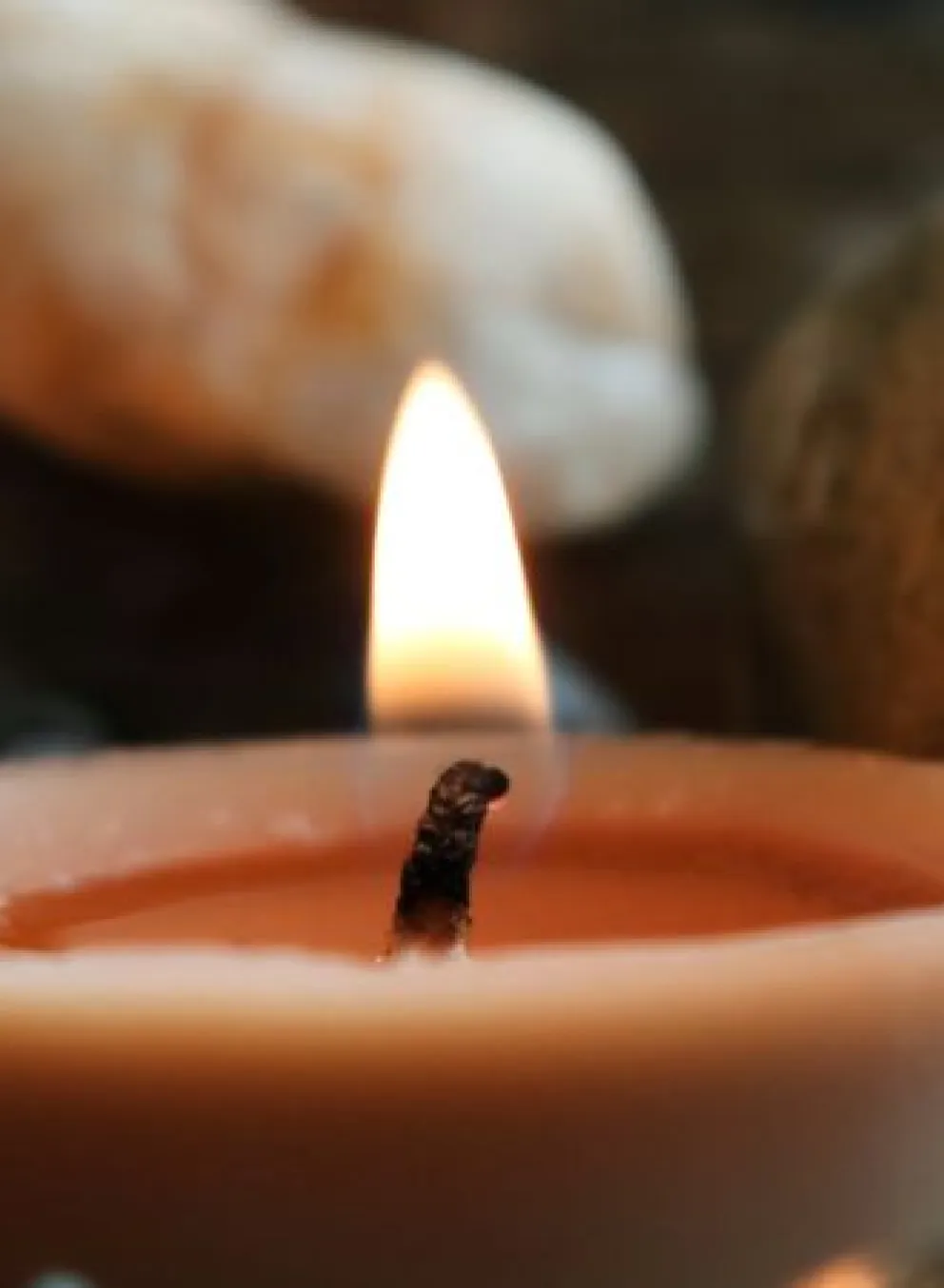 candle nestled in rocks