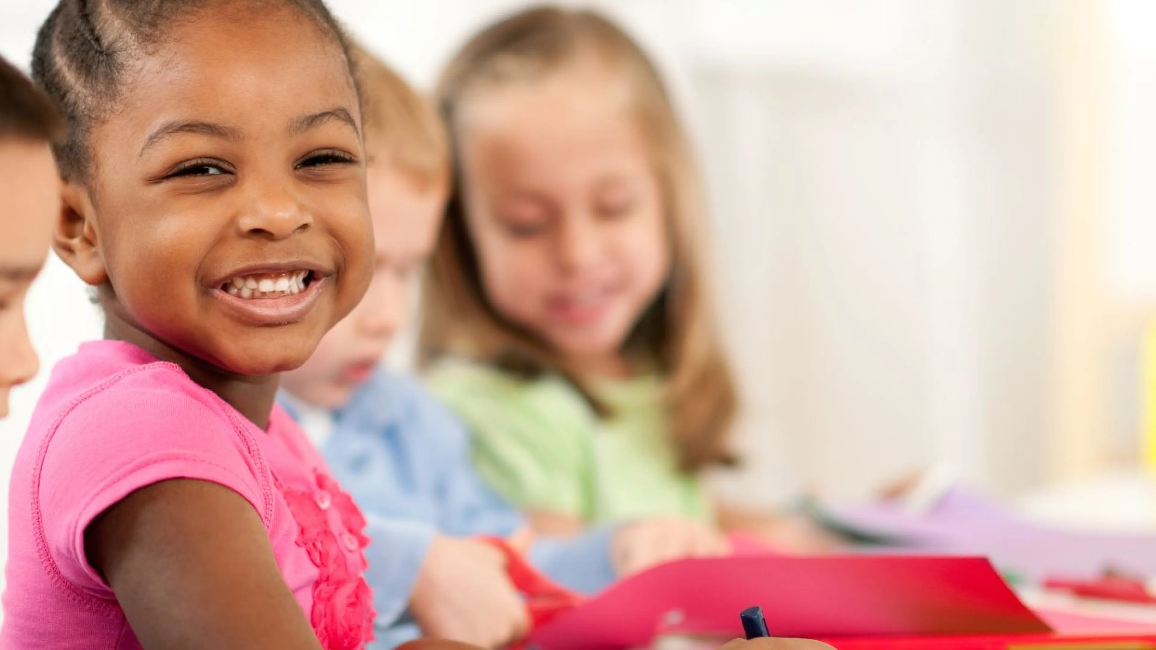 preschool children sitting at table coloring