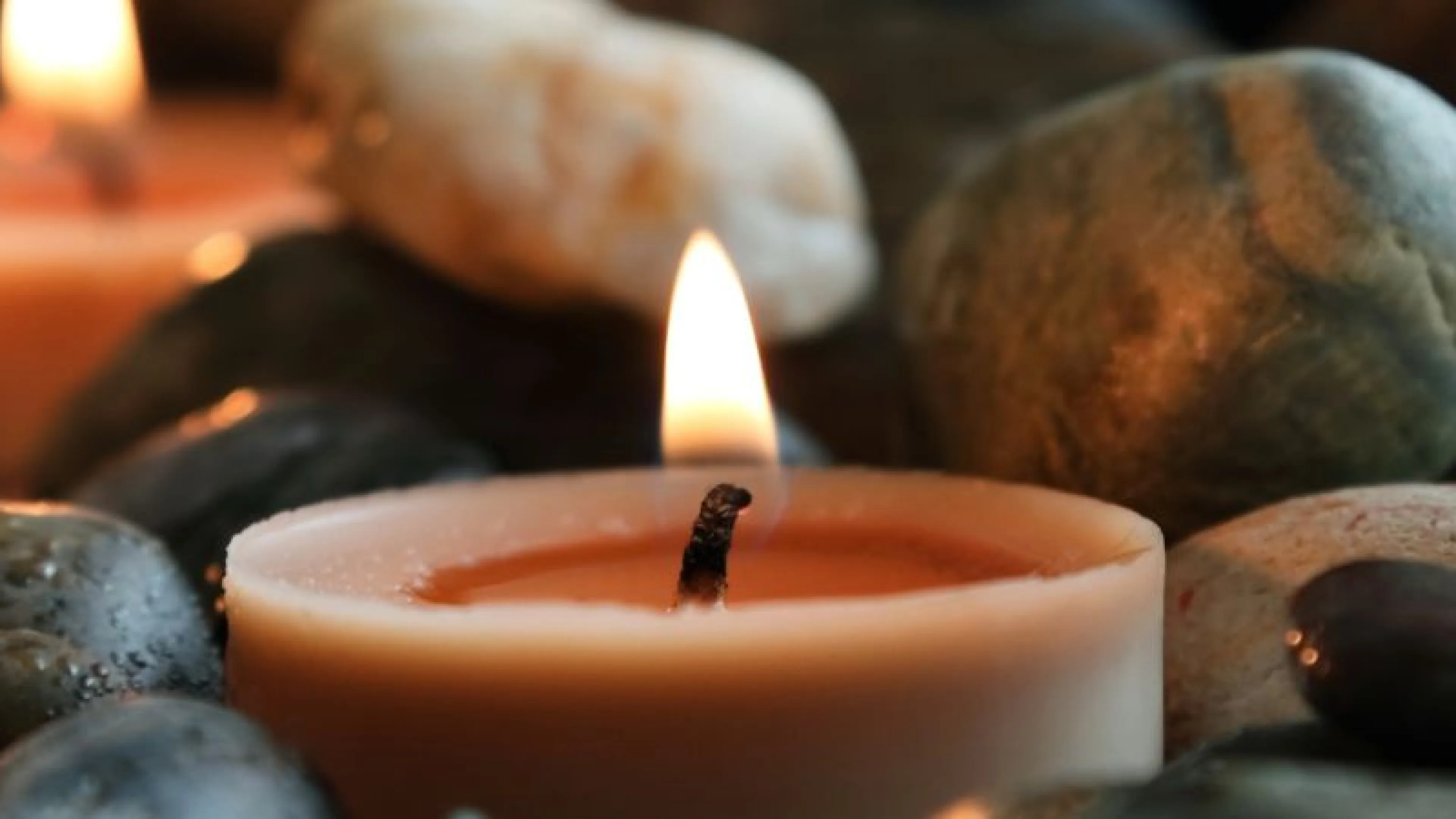 candle nestled in rocks