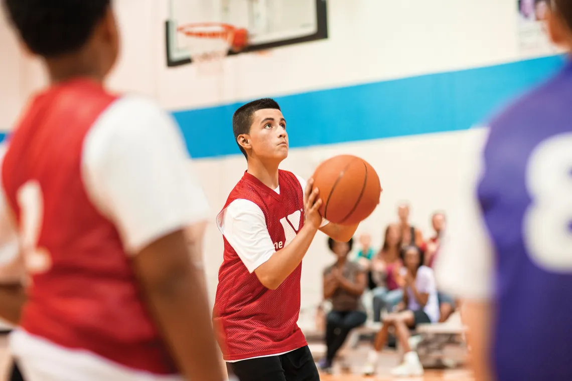 young teens playing basketball